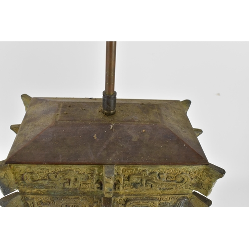 223 - A Chinese heavy bronze lamp in the archaic design, of tapered rectangular form, on a wooden base, wi... 