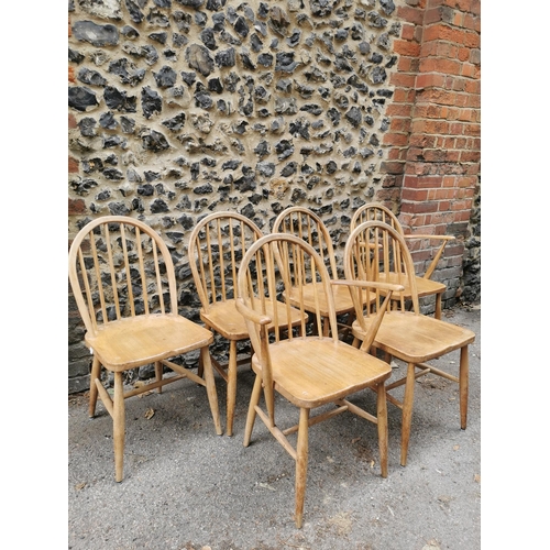 60 - A mid century blonde elm circular drop leaf table together with a set of six Ercol windsor dining ch... 