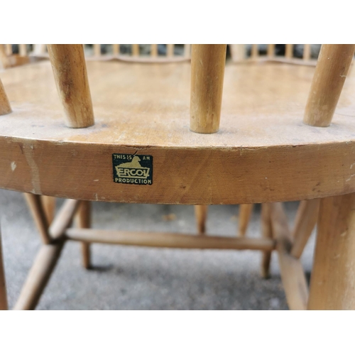 60 - A mid century blonde elm circular drop leaf table together with a set of six Ercol windsor dining ch... 