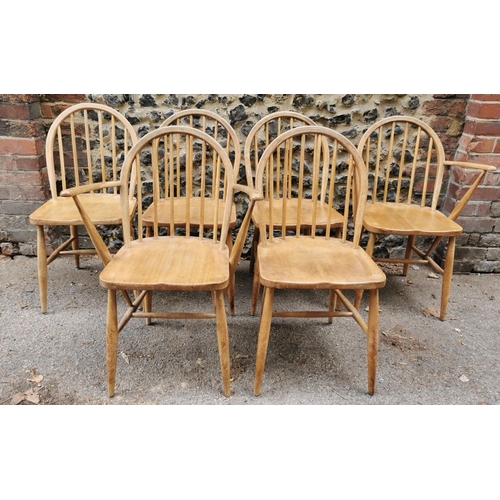 60 - A mid century blonde elm circular drop leaf table together with a set of six Ercol windsor dining ch... 