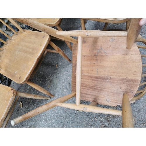 60 - A mid century blonde elm circular drop leaf table together with a set of six Ercol windsor dining ch... 