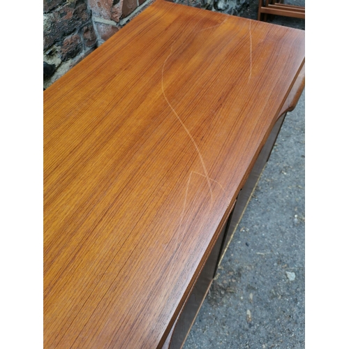 61 - A mid-20th century McIntosh teak sideboard, with two central cupboard doors flanked to one side with... 