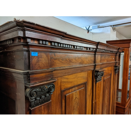 472 - An early 19th century mahogany large German breakfront cabinet with a dentil moulded cornice above a... 