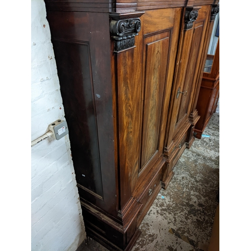 472 - An early 19th century mahogany large German breakfront cabinet with a dentil moulded cornice above a... 