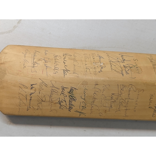 479 - A signed Slazenger cricket bat, signed by the 1971 teams of England and India to one side, and Middl... 