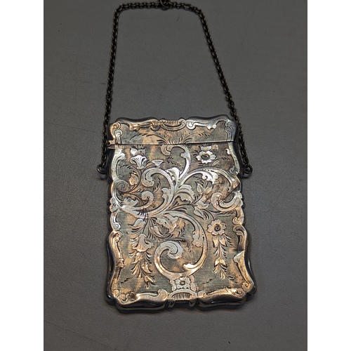 505 - A Victorian silver card case having floral decorated engraving and initials E.M.K. Location: CAB1