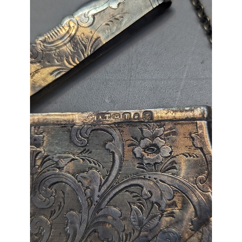 505 - A Victorian silver card case having floral decorated engraving and initials E.M.K. Location: CAB1