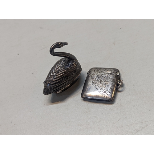 508 - An early 20th century silver vesta case, together with a late 19th century silver condiment pot in t... 