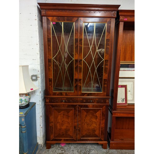 511 - A reproduction mahogany breakfront sideboard having three drawers and four panelled doors, 91cm h x ... 