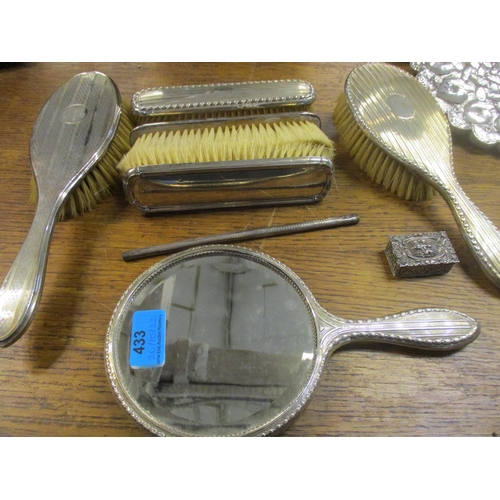 433 - A selection of silver clad dressing table brushes, a comb (without teeth), and a hand mirror (mixed ... 