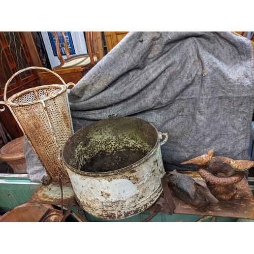 489 - Garden related items to include a metal duck, a small birdbath, a cast metal cauldron on a stand, an... 