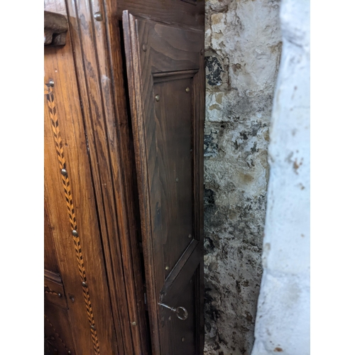 494 - A 19th century Continental cabinet having marquetry inlaid, metal studs, two side doors and central ... 