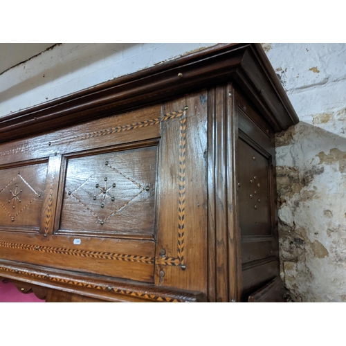 494 - A 19th century Continental cabinet having marquetry inlaid, metal studs, two side doors and central ... 