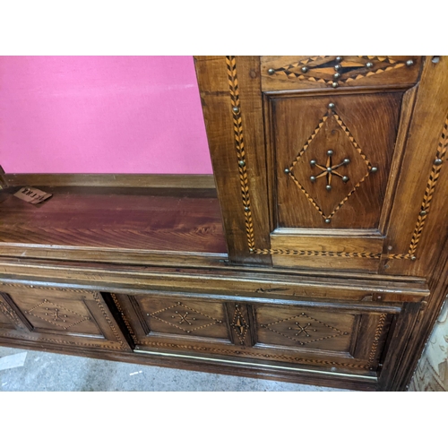 494 - A 19th century Continental cabinet having marquetry inlaid, metal studs, two side doors and central ... 