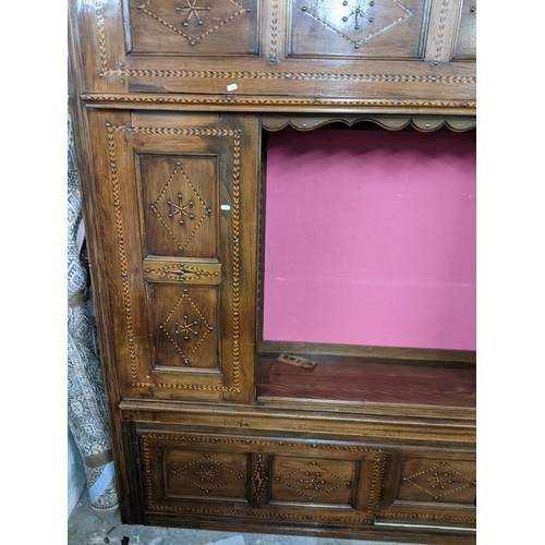 494 - A 19th century Continental cabinet having marquetry inlaid, metal studs, two side doors and central ... 