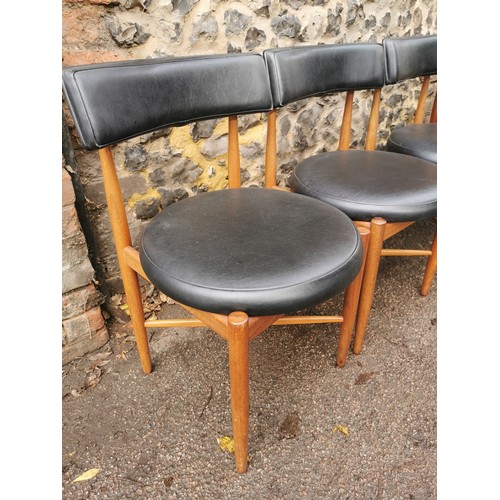 53 - A mid-century teak circular table, together with a set of four G-Plan 'Fresco' black vinyl and teak ... 