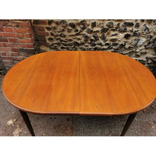 54 - A G-Plan extending dining table together with a set of six G-Plan 'Fresco' black vinyl and teak fram... 