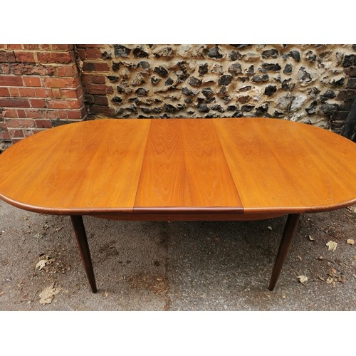 54 - A G-Plan extending dining table together with a set of six G-Plan 'Fresco' black vinyl and teak fram... 