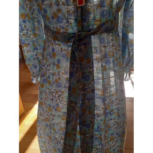 116 - A 1970's blue cotton full length dress with ruffled hem having small floral design throughout togeth... 