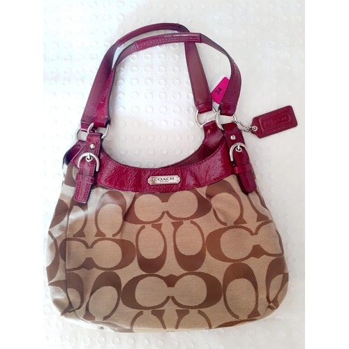 34 - Coach-A Soho signature canvas and maroon leather boho handbag, serial number H1293-F19445 having 3 z... 