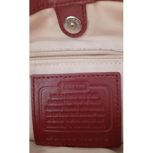 34 - Coach-A Soho signature canvas and maroon leather boho handbag, serial number H1293-F19445 having 3 z... 