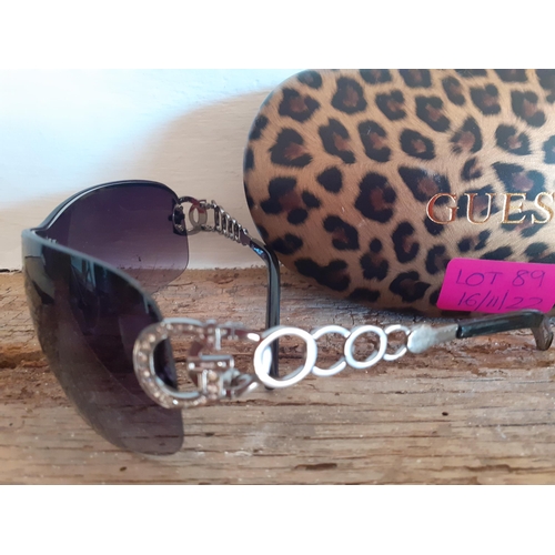 89 - Guess-A pair of ladies black frameless sunglasses with ornate silver tone arms and iconic 'G' encirc... 