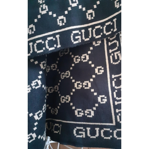 9 - Gucci-A black and tan jacquard woollen wrap in double 'G' design, genuine by repute, 72cm x 108cm . ... 