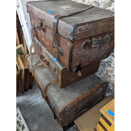 220 - Four canvas and wooden trunks with metal strapwork, one with a brass lock
Location: G