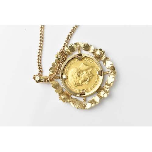 120 - A 9ct yellow gold flat curb link chain necklace with a George V, 1911 sovereign coin in a 9ct gold f... 