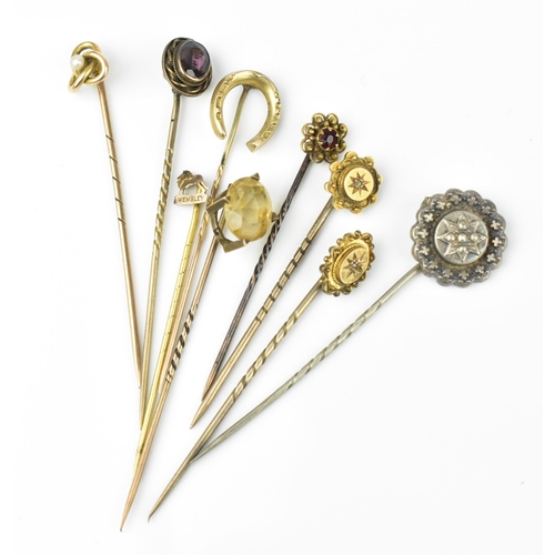 129 - A collection of stick pins, to include some gold ones, with gemstones, two with diamond accent, one ... 