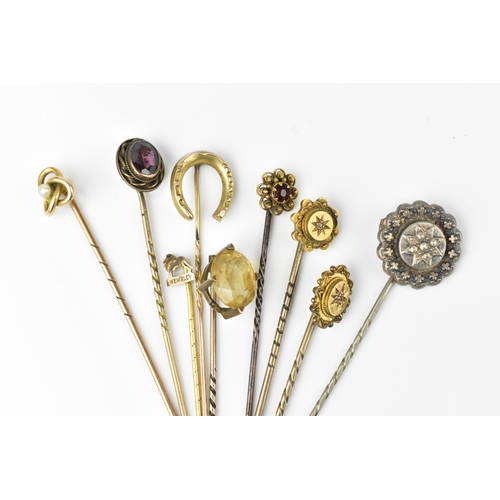 129 - A collection of stick pins, to include some gold ones, with gemstones, two with diamond accent, one ... 