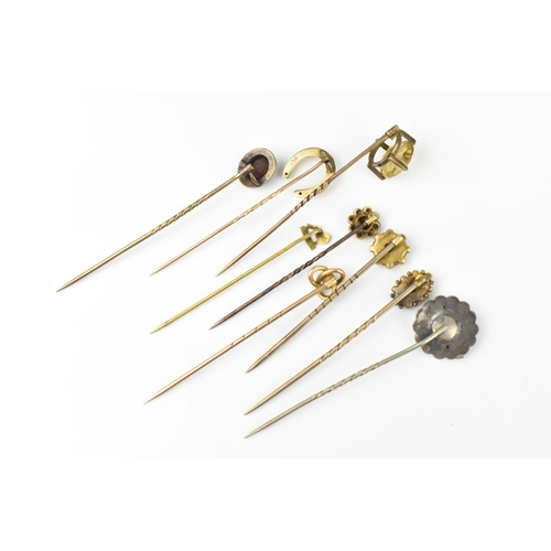 129 - A collection of stick pins, to include some gold ones, with gemstones, two with diamond accent, one ... 