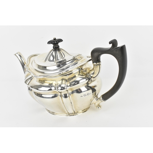 131 - A George V silver teapot by Josiah Williams & Co, London 1922, with moulded border, ebony finial and... 