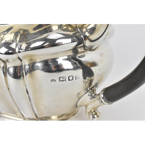 131 - A George V silver teapot by Josiah Williams & Co, London 1922, with moulded border, ebony finial and... 