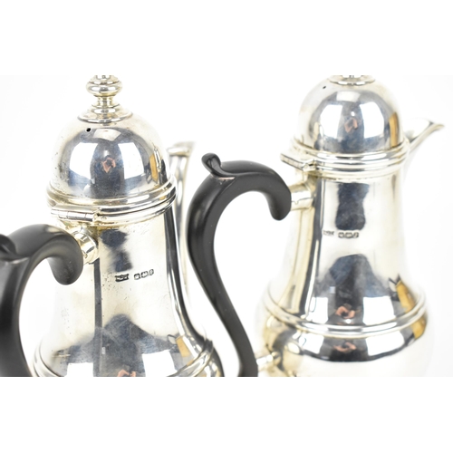 134 - A pair of George V silver hot water and coffee pot by Mappin & Webb, each of baluster form with dome... 