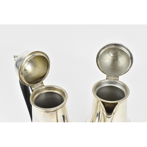 134 - A pair of George V silver hot water and coffee pot by Mappin & Webb, each of baluster form with dome... 