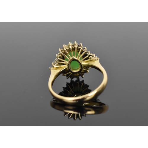 141 - A 14ct yellow gold, diamond and green jade dress ring, with central oval cabochon jade in a halo of ... 