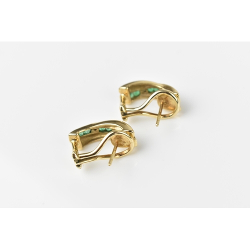 142 - A pair of 9ct yellow gold, diamond and emerald earrings, with channel set princess cut emeralds in s... 