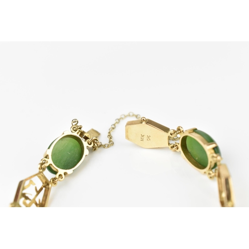 144 - A 14ct yellow gold and green jade bracelet, with Chinese character links separated with jade cabocho... 