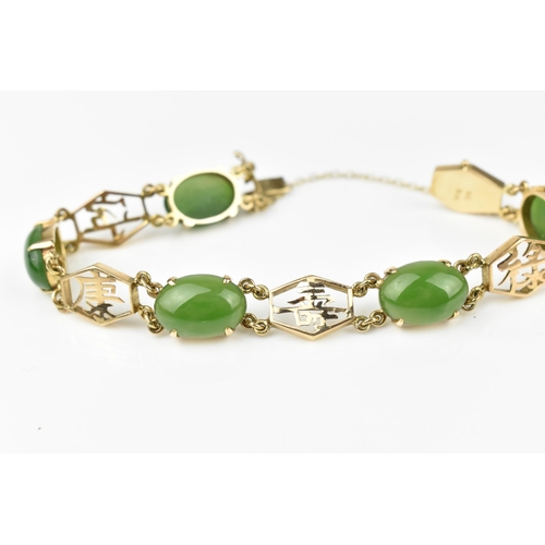 144 - A 14ct yellow gold and green jade bracelet, with Chinese character links separated with jade cabocho... 