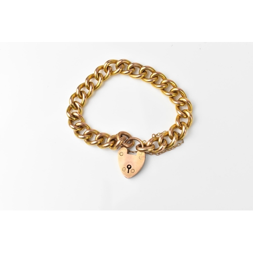 146 - A 9ct yellow gold curb link bracelet with heart padlock and safety chain, in heart shaped fitted box... 