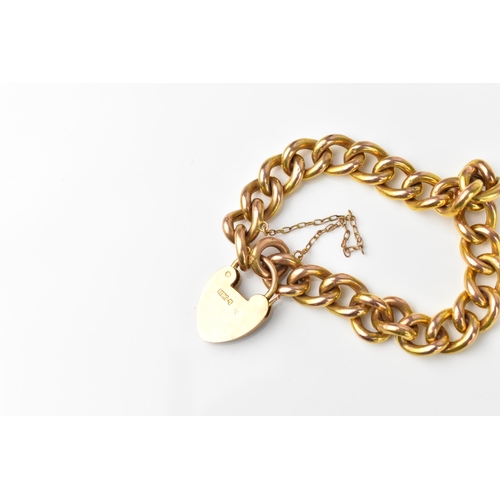 146 - A 9ct yellow gold curb link bracelet with heart padlock and safety chain, in heart shaped fitted box... 