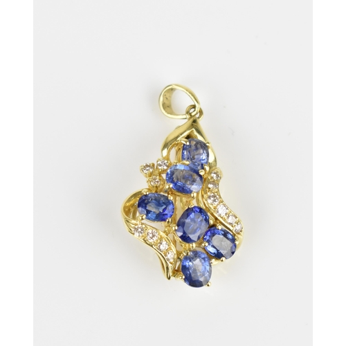 150 - An 18ct yellow gold, diamond and sapphire pendant/brooch, inset with six cornflower blue sapphires f... 