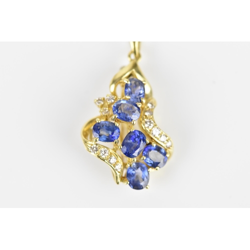 150 - An 18ct yellow gold, diamond and sapphire pendant/brooch, inset with six cornflower blue sapphires f... 