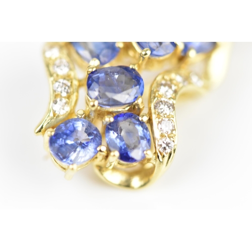 150 - An 18ct yellow gold, diamond and sapphire pendant/brooch, inset with six cornflower blue sapphires f... 