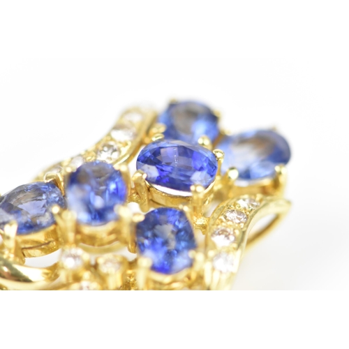 150 - An 18ct yellow gold, diamond and sapphire pendant/brooch, inset with six cornflower blue sapphires f... 