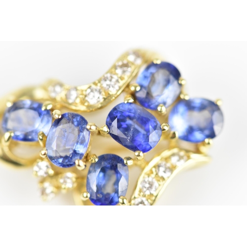 150 - An 18ct yellow gold, diamond and sapphire pendant/brooch, inset with six cornflower blue sapphires f... 