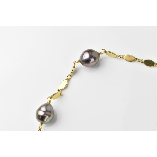 151 - A yellow metal and baroque cultured Tahitian pearl necklace, with three flat links between each pear... 