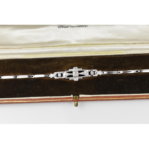 152 - An Art Deco 18ct white gold and diamond bracelet, with stretch bracelet, inset with thirteen central... 