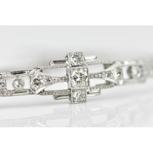 152 - An Art Deco 18ct white gold and diamond bracelet, with stretch bracelet, inset with thirteen central... 